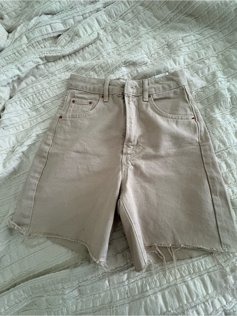 High-Rise Raw Hem Longline Denim Shorts in Beige